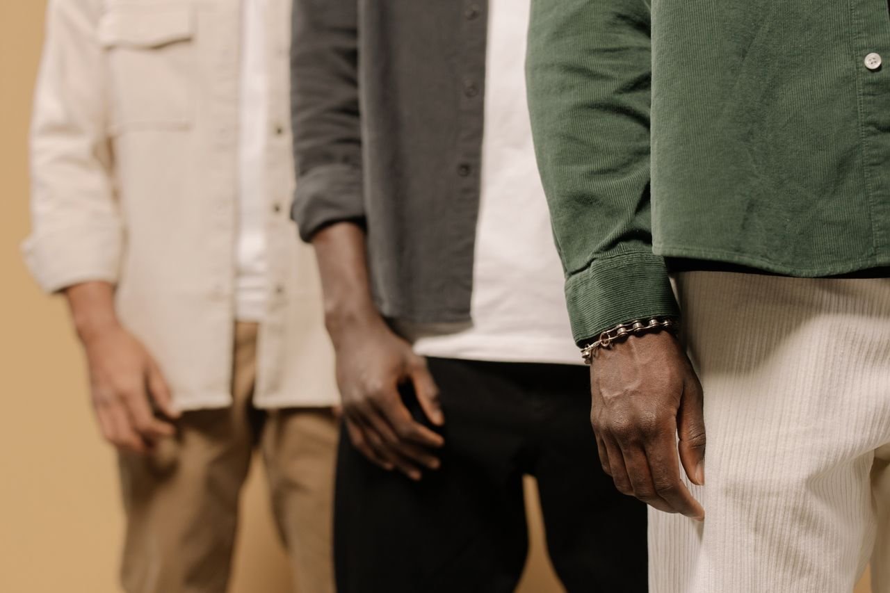 Stylish men's fashion shoot showcasing casual shirts and pants in neutral tones.